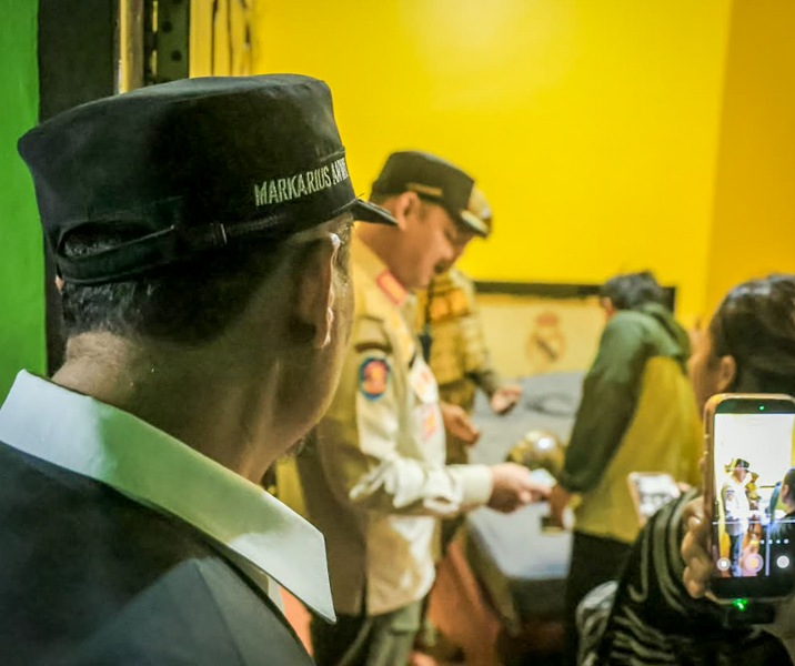 Wawako Pekanbaru Markarius Anwar menyaksikan Kepala Satpol PP Desheriyanto memeriksa identitas penghuni tempat penginapan. Foto: Istimewa.
